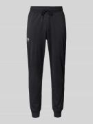 Under Armour Relaxed Fit Trainingshose mit Reißverschlusstaschen in Bl...