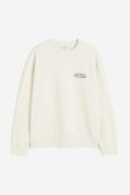 H&M Bedrucktes Sweatshirt in Loose Fit Cremefarben/Stones, Sweatshirts...